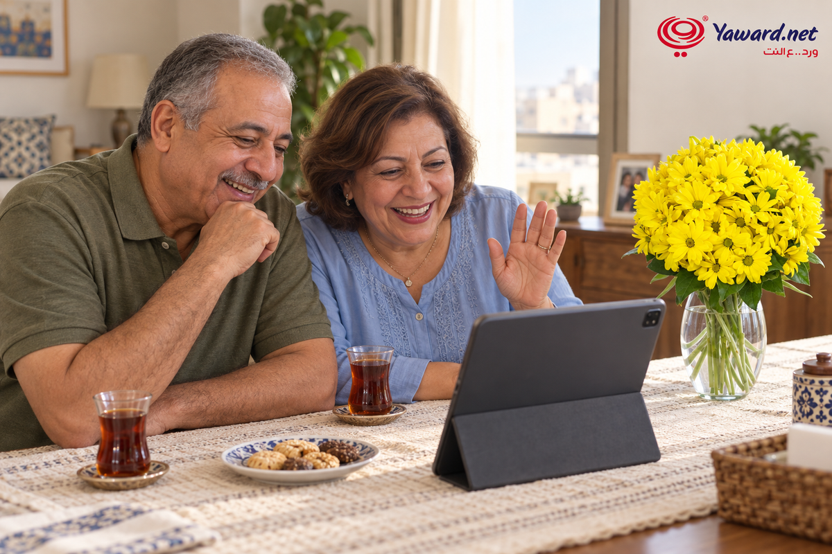 Parents sharing a relaxed video call beside yellow flowers at home / أم وأب بيتكلموا في مكالمة فيديو جنب ورد أصفر في البيت